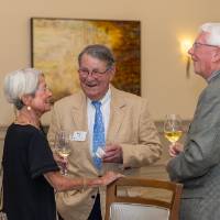 Happy Fox smiling in conversation with two other guests